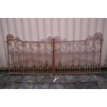 A PAINTED WROUGHT IRON GATE, with scrolled details, each gate length 139cm x height 124cm (