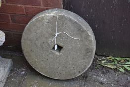 A SMALL SANDSTONE MILL WHEEL, diameter 45cm (condition: aged wear and tear)
