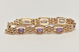 A 9CT GOLD AMETHYST BRACELET, seven oval cut amethyst prong set in yellow gold, interspaced
