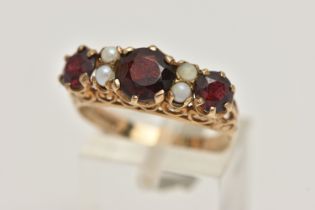 A 9CT GOLD GARNET AND SPLIT PEARL RING, designed as three graduated circular garnets interspaced