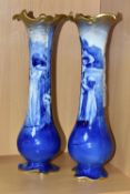 A NEAR PAIR OF ROYAL DOULTON 'BLUE CHILDREN' VASES, of slender baluster form, with gilt scrolling