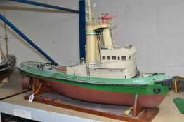 A MOTORISED MODEL SHIP, Burutu, rests on a stand, motor in internal compartment, length