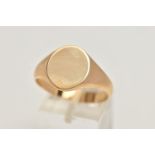 A YELLOW METAL SIGNET RING, plain polished oval signet, unmarked, ring size X, approximate gross