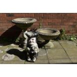 A COMPOSITE GARDEN URN, with a circular tapered top, on a base with three fish, diameter 55cm x