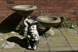 A COMPOSITE GARDEN URN, with a circular tapered top, on a base with three fish, diameter 55cm x