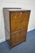 A BURR WALNUT TWO DOOR CABINET, with four drawers, width 71cm x depth 51cm x height 135cm (condition