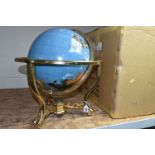 A BOXED TABLE TOP GLOBE, marine blue gemstone globe with a brass coloured stand, three feet and