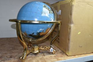 A BOXED TABLE TOP GLOBE, marine blue gemstone globe with a brass coloured stand, three feet and