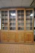 A LARGE 19TH CENTURY OAK BOOKCASE, the top breakfront section fitted with four astragal glazed