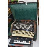 A CASED SCANDALLI SCOTT WOOD FOUR ACCORDIAN, body straps detached and worn, hand strap in good