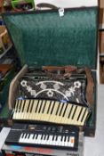 A CASED SCANDALLI SCOTT WOOD FOUR ACCORDIAN, body straps detached and worn, hand strap in good
