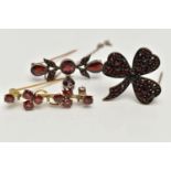 THREE EARLY 20TH CENTURY GARNET BROOCHES, two bar brooches and a clover bohemian garnet brooch, (