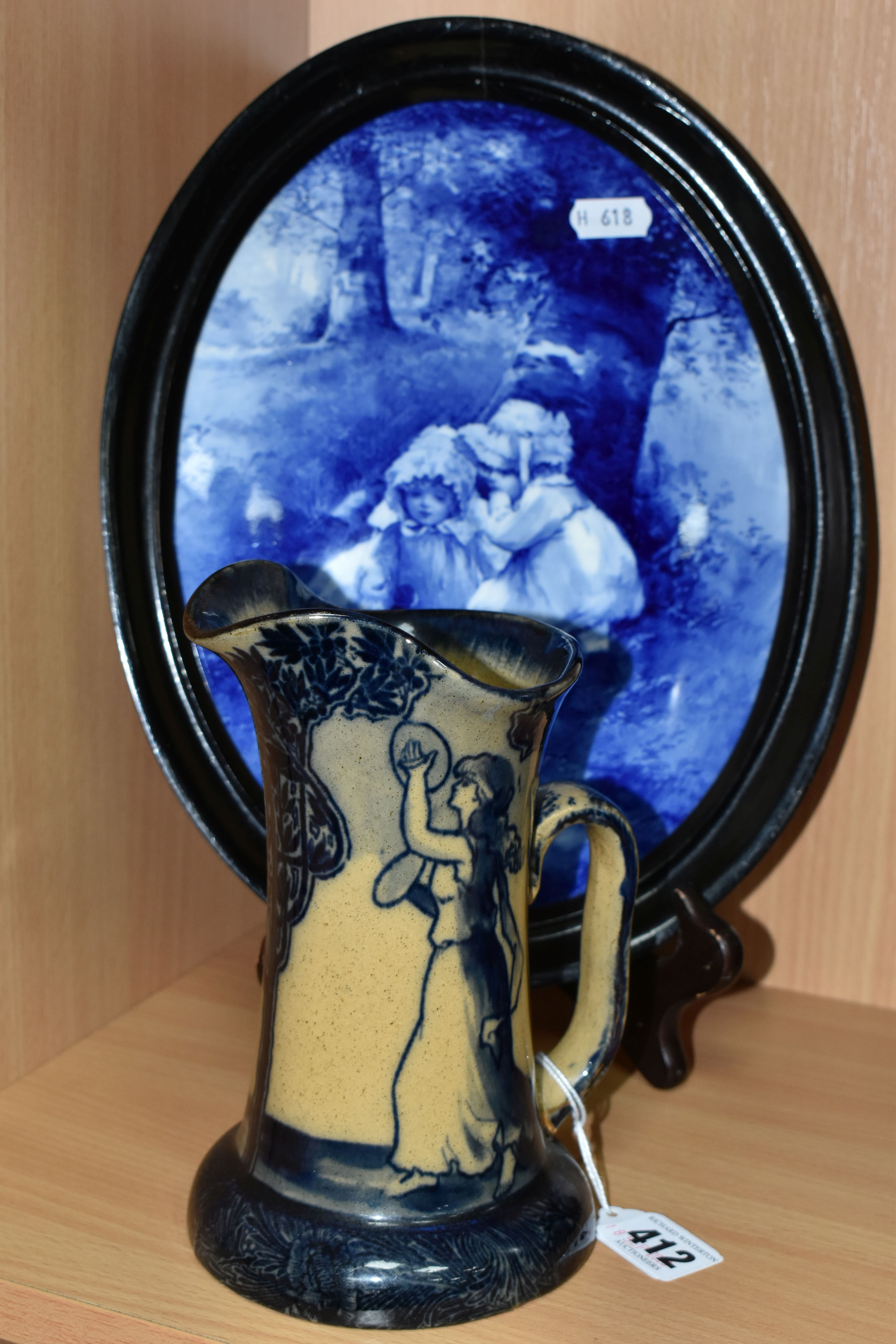 A ROYAL DOULTON BLUE CHILDREN PLAQUE AND A MORRISIAN WARE JUG, the framed oval plaque decorated with