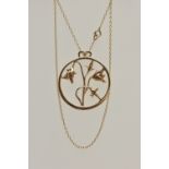 A 9CT GOLD OPEN WORK FLORAL NECKLACE, a large yellow gold circular pendant with an arrangement of