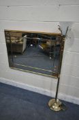 A MODERN GILT FRAMED BEVELLED EDGE WALL MIRROR, 115cm x 84cm, and a brass standard lamp, with a