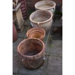 A PAIR OF HIGHLY WEATHERED TERRACOTTA GARDEN PLANTERS, diameter 46cm x height 35cm, a cylindrical