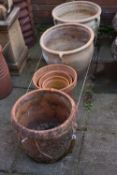 A PAIR OF HIGHLY WEATHERED TERRACOTTA GARDEN PLANTERS, diameter 46cm x height 35cm, a cylindrical