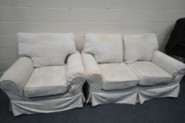 A CREAM COVERED TWO PIECE LOUNGE SUITE, comprising a two seater settee, and a pair of armchairs (