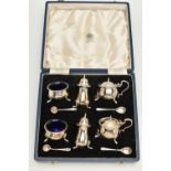 A CASED MAPPIN & WEBB ELIZABETH II SILVER TEN PIECE CRUET SET, of circular form on three cabriole