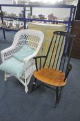 AN ERCOL STYLE EBONISED ROCKING CHAIR, along with a wicker armchair (condition report: good) (2)