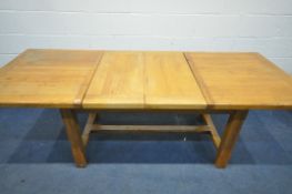 A LIGHT OAK EXTENDING DINING TABLE, with two drawers, on block legs, united by a H stretcher,