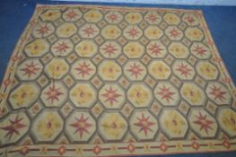 A 1970'S WOOL RUG, with a repeating pattern, 242cm x 197cm (condition report: in need of minor