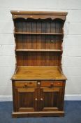 A MODERN PINE DRESSER, with two drawers, width 98cm x depth 49cm x height 187cm x height of base