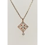 AN EARLY 20TH CENTURY ART DECO PENDANT, a rose gold quatrefoil open work pendant, principally set