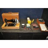 A LEATHER CASED MANUAL SINGER SEWING MACHINE, serial number 15 040 687, an Avometer 8 in original