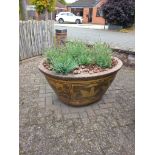 A LARGE COMPOSITE OVAL TAPERED PLANTER, thats decorated with an oriental pattern, width 118cm x