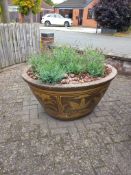A LARGE COMPOSITE OVAL TAPERED PLANTER, thats decorated with an oriental pattern, width 118cm x