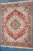 A LARGE WOOLLEN PERSIAN FLORAL PATTERNED RUG, with a red and cream field, 360cm x 250cm (condition