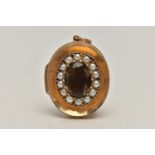 A 9CT GOLD SMOKY QUARTZ AND SPLIT PEARL LOCKET, concaved locket principally set with an oval cut