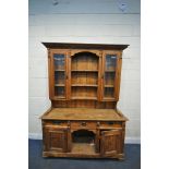 A 19TH CENTURY PINE DRESSER, the later top with arrangement of cupboards flanking open shelves, over