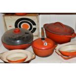 A GROUP OF CAST IRON AND STONEWARE COOKWARE, thirteen pieces to include boxed Le Creuset and other