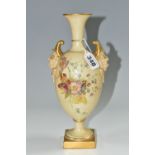 A ROYAL WORCESTER VASE WITH MASK BOSS HANDLES, a collared flared neck vase in a blush ivory ground