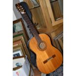 AN EPIPHONE ACOUSTIC GUITAR, made in Japan, with a hard case, solid cedar top, mahogany back and