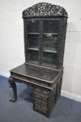 A 19TH CENTURY EBONISED ROSEWOOD CHINESE BOOKCASE ABOVE DESK, heavily carved throughout with