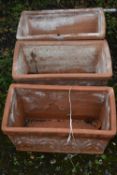 THREE ITALIAN TERRACOTTA RECTANGULAR GARDEN PLANTERS, with floral details, length 54cm x depth