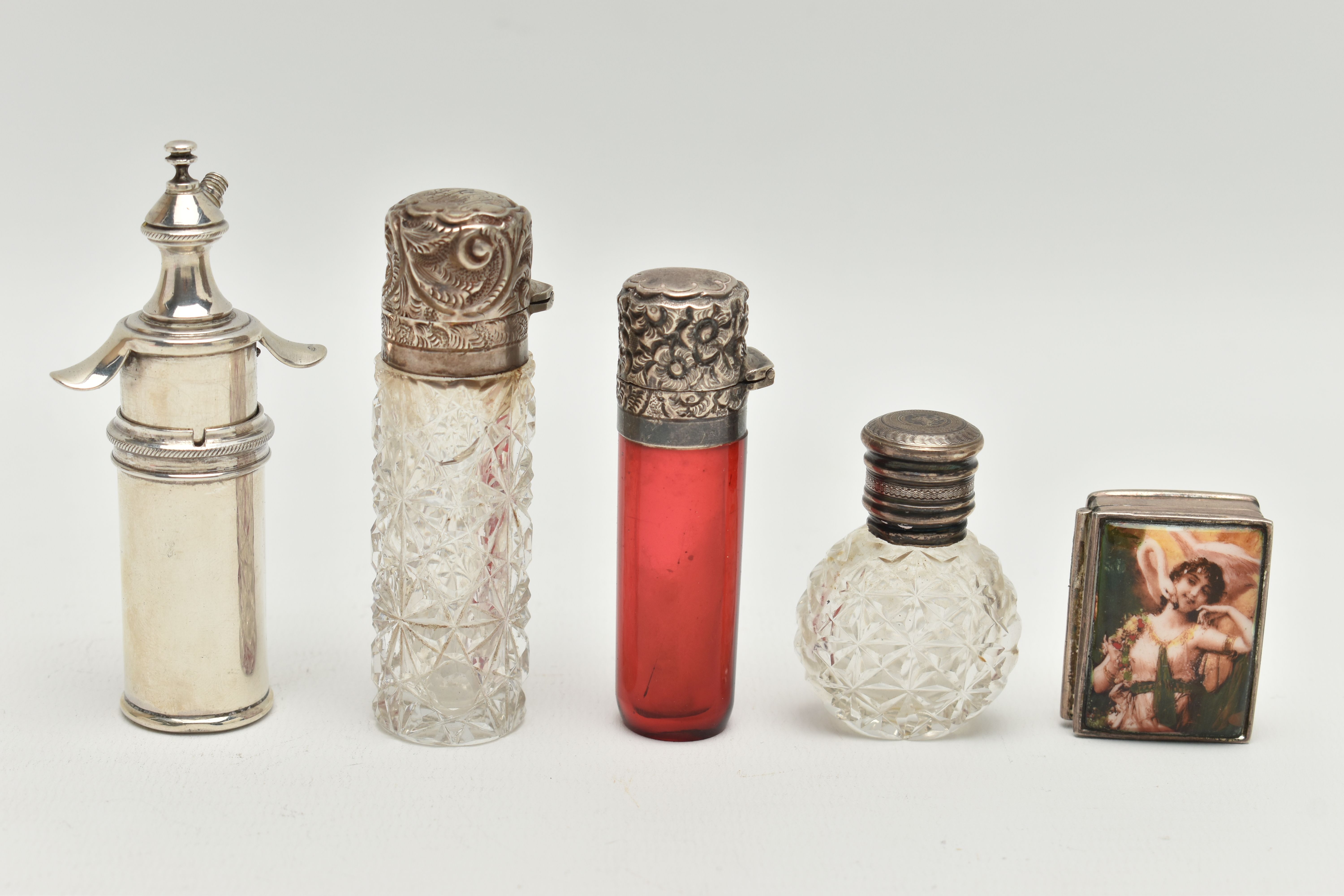 FIVE ITEMS, to include a red glass scent bottle with a silver embossed, hinged cover, hallmarked '