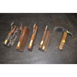 FOUR VARIOUS VINTAGE WOODEN PLANES, along with a PW Walker number 3 adze tool (5)