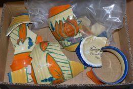 A BOX CONTAINING BROKEN PIECES OF AN ISIS FANTASQUE VASE BY CLARICE CLIFF, 'Lily' pattern, ribbed