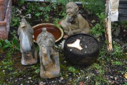 A SELECTION OF GARDEN ITEMS, to include two distressed camel figures, a seated creature, etc (