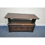AN EARLY 20TH CENTURY CARVED OAK MONKS BENCH, with a pivoting top, and storage compartment, width
