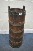 AN OAK COOPERED BARREL STICK STAND, with iron banding, diameter 33cm x height 87cm (condition