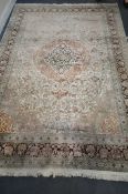 A LARGE 2OTH CENTURY KASHAN CREAM AND BLUE FIELD SILK RUG, 314cm x 212cm (condition report: in
