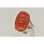 A CARVED CORAL RING, a cameo ring depicting a lady with flowers in her hair, collect set in rose