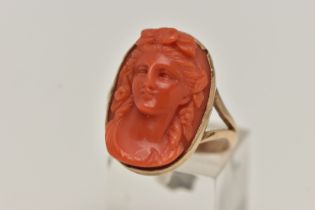 A CARVED CORAL RING, a cameo ring depicting a lady with flowers in her hair, collect set in rose