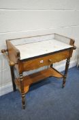 A VICTORIAN FLAME MAHOGANY WASHSTAND, with a marble top and gallery, towel rails flanking a single