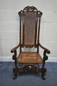 A 19TH CENTURY CAROLEAN STYLE MAHOGANY HIGH BACK ARMCHAIR, with scrolled and foliate crest, turned